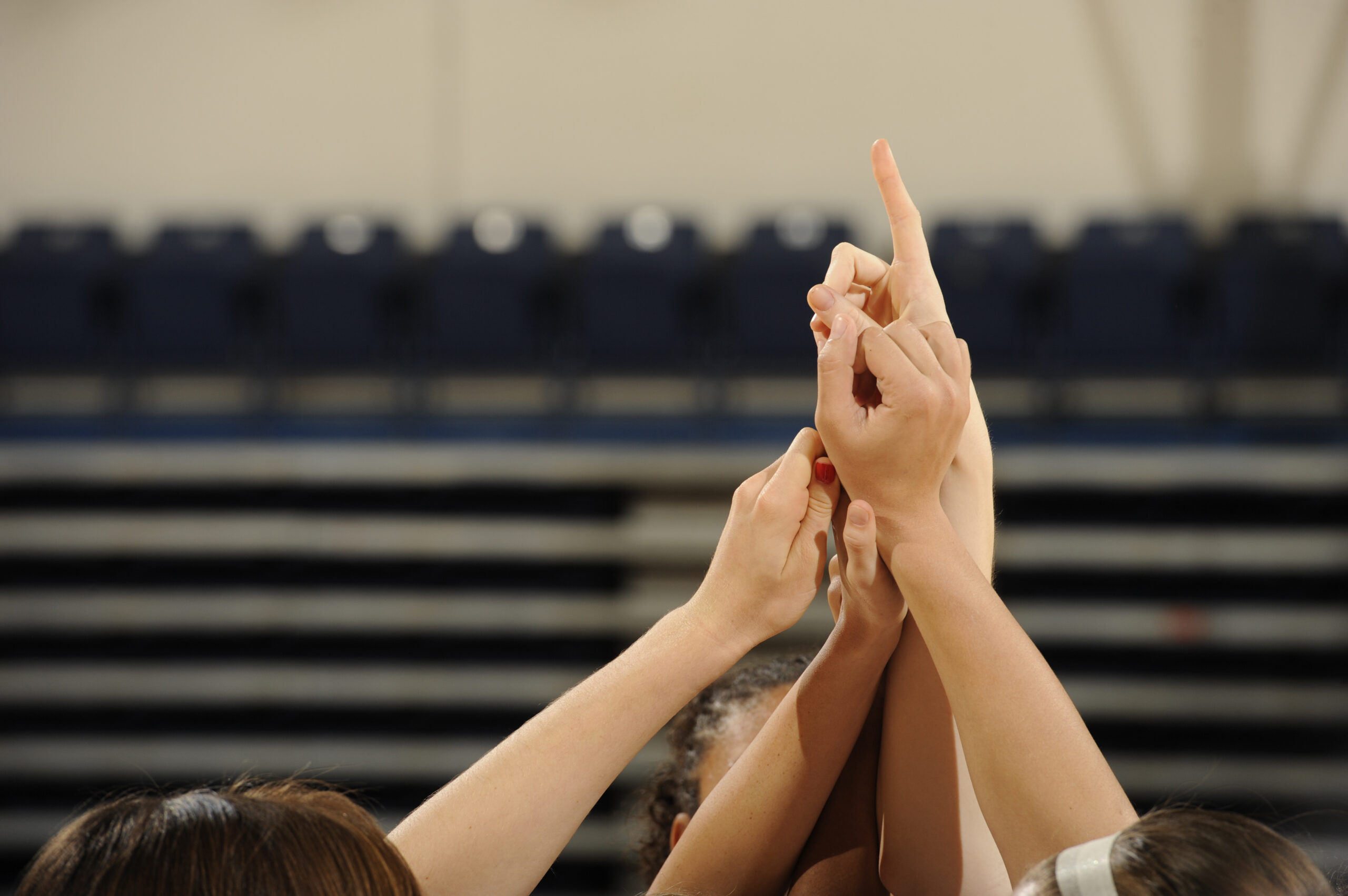 Women hold up theirs fingers gesturing 
